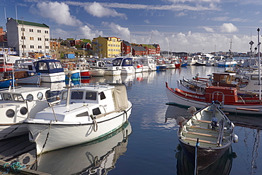 Colourful boats and picturesque gabled buildings along the quayside in Vestaravag harbour, Torshavn, Streymoy, Faroe Islands (Faroes), Denmark, Europe