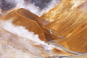 Hikers exploring the very active hot spring area at Kerlingarfjoll, where Kerlingarfjoll Mountains in the interior are a massif of rhyolitic domes rising to 1477m, Iceland, Polar Regions