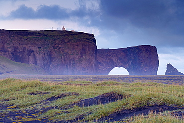 Dyrholaey inselberg and cliffs, southernmost point of Iceland, from the low-lying coast near Vik, Iceland, Polar Regions