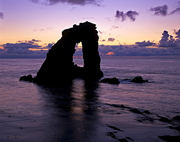 Gaada Stack natural arch, 45 m high, at sunset, Foula, Shetland Islands, Scotland, United Kingdom, Europe