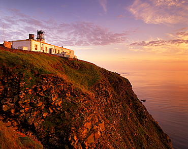 Sunset over Sumburgh Head lighthouse, built by Robert Stevenson in 1821 and now an RSPB office, Shetland Islands, Scotland, United Kingdom, Europe