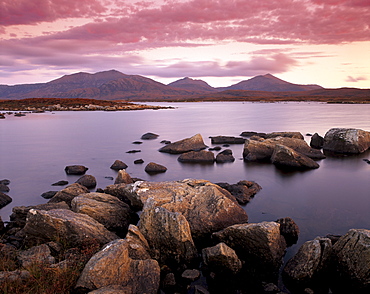 Loch Druidibeg Nature Reserve at sunset, with Hecla, Ben Corodale and Beinn Mhor behind, South Uist, Outer Hebrides, Scotland, United Kingdom, Europe