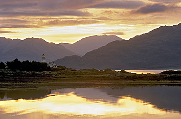 Sunrise over Isleornsay and lighthouse, Knoydart mountains behind, Isle of Skye, Inner Hebrides, Scotland, United Kingdom, Europe