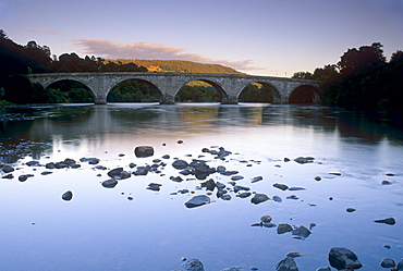 The seven-arched Dunkeld Bridge over the River Tay at dusk, built by Thomas Telford, Dunkeld, Perth and Kinross, Scotland, United Kingdom, Europe