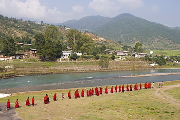 Buddhist monks from Punakha Dzong going to the river to meditate, Punakha, Bhutan, Asia