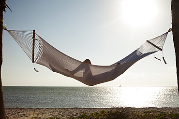 Woman in a hammock on the beach, Florida, United States of America, North America