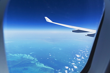 Airplane flying over Bahamas sand banks, West Indies, Central America