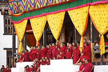 Buddhist monks watching festival (Tsechu), Trashi Chhoe Dzong, Thimphu, Bhutan, Asia