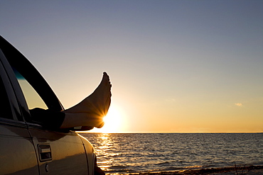 Man's feet at sunset, Key Byscaine, Miami, Florida, United States of America, North America