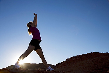 Woman stretching, Monument Valley Navajo Tribal Park, Arizona Utah border, United States of America, North America