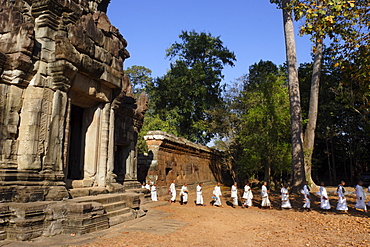 A procession of Buddhist nuns file through the temples of Angkor, UNESCO World Heritage Site, Cambodia, Indochina, Southeast Asia, Asia