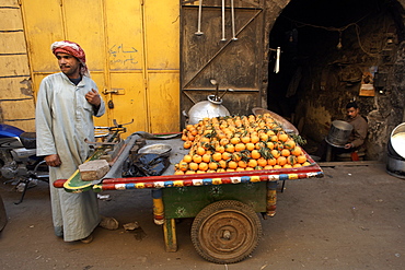 A man selling oranges in Khan al-Khalili, Cairo, Egypt, North Africa, Africa