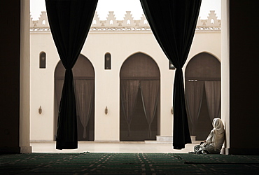 Woman sitting in the Mosque of Al-Hakim, Cairo, Egypt, North Africa, Africa