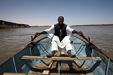 A boatman rows along the Nile river near Karima, Sudan, Africa