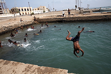 Children play in an ocean pool, Massawa, Red Sea, Eritrea, Africa