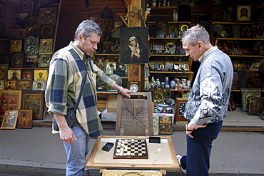 Men play checkers in Izmailovsky Market, Moscow, Russia, Europe