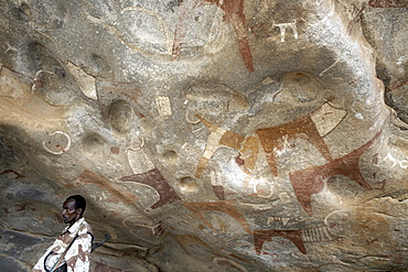 A Somaliland soldier stands guard at the 5000 year-old cave paintings in Lass Geel caves, Somaliland, northern Somalia, Africa