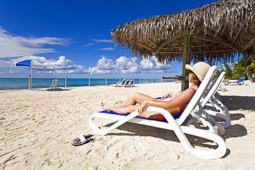 Woman on a lounger, Princess Cays, Eleuthera Island, Bahamas, Greater Antilles, West Indies, Caribbean, Central America