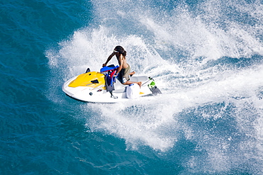 Man on a jet ski, Nassau harbor, New Providence Island, Bahamas, West Indies, Central America