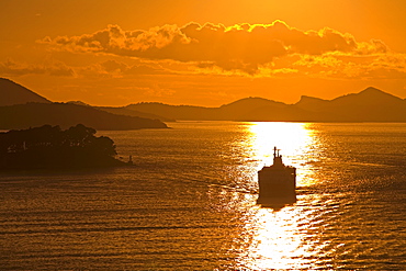 Cruise ship sails into sunset, Port of Dubrovnik, Dalmatia, Croatia, Europe