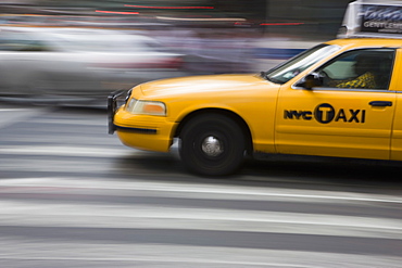 New York taxi cab driving fast over a pedestrian crossing, Manhattan, New York, United States of America, North America