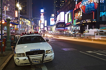 NYPD police car parked at Times Square at night, Manhattan, New York, United States of America, North America