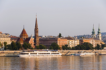 Boats on the Danube moored in front of the Calvinist Church, Budapest, Hungary, Europe