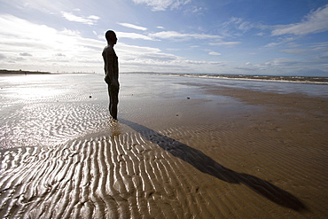 Another Place sculpture by Antony Gormley on the beach at Crosby, Liverpool, England, United Kingdom, Europe