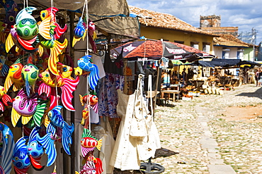 A display of colourful wooden fish for sale in a craft market in Trinidad, Sancti Spiritus Province, Cuba, West Indies, Central America