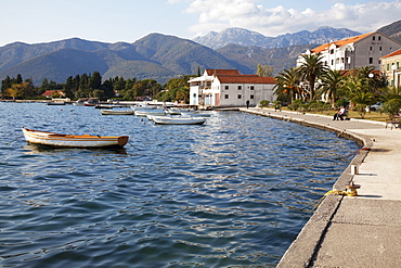 Waterfront near the newly developed Marina in Porto Montenegro with mountains behind, Montenegro, Europe