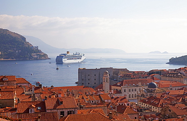 Rooftops, cruise ship and the island of Lokrum from Dubrovnik Old Town walls, Dubrovnik, Croatia, Europe