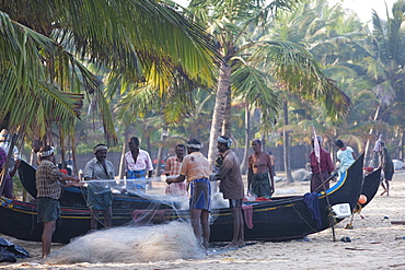 Fishermen sorting their nets at Marari Beach, Kerala, India, Asia 