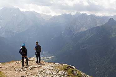 Climbers on the Sassolungo mountains in the Dolomites near Canazei, Italy, Europe