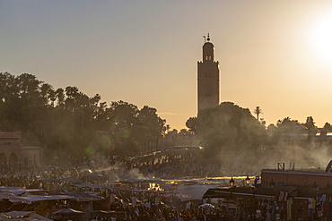 Evening light on the busy square of Place Jemaa el-Fna with the minaret of the Koutoubia Mosque in the distance, UNESCO World Heritage Site, Marrakech, Morocco, North Africa, Africa