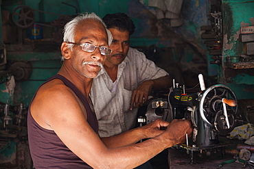 Man repairing an old sewing machine in the city of Jodhpur, Rajasthan, India, Asia