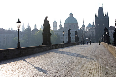 Statues on Charles Bridge, UNESCO World Heritage Site, with the dome of the Church of St. Francis and Old Town Bridge Tower in the background, Old Town, Prague, Czech Republic, Europe