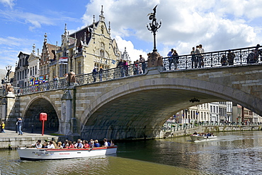 Pleasure boat on the river passing under St. Michaels bridge, Ghent, Flanders, Belgium, Europe