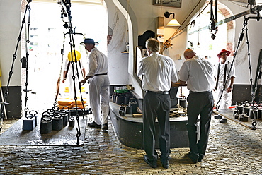 Weighing cheese wheels in the weighing house, Friday cheese market, Waagplein Square, Alkmaar, North Holland, Netherlands, Europe