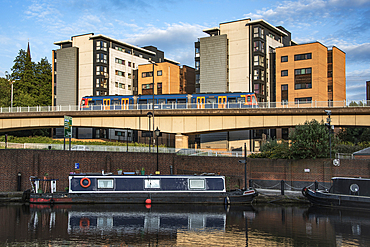 Overhead tram line overlooking canal boats at Victoria Quays, formerly the Canal Basin, Castle Gate Quarter,