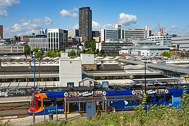 Sheffield Railway station viewed from the east with a Supertram stop in the foreground and the city centre behind, Granville Street,