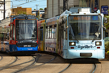 Sheffield trams known as 'Supertram' approaching a stop in Church Street, Cathedral Quarter,