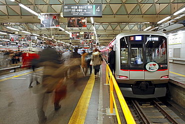 Commuters moving through Shibuya Station during rush hour, Shibuya District, Tokyo, Japan, Asia