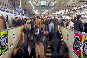 Commuters moving through Shibuya Station during rush hour, Shibuya District, Tokyo, Japan, Asia