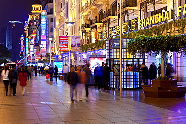 Pedestrians at night walking past stores on Nanjing Road, Shanghai, China, Asia