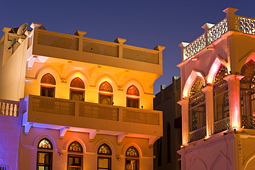 Colourfully illuminated latticed houses along the corniche, Mutrah, Muscat, Oman, Middle East