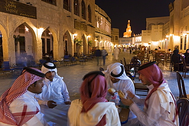 A group of men in Arabian dress in the restored Souq Waqif, Doha, Qatar, Middle East