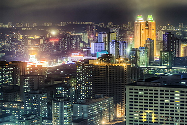 New modern buildings in the centre of Pyongyang colourfully illuminated at night, Pyongyang, Democratic People's Republic of Korea (DPRK), North Korea, Asia