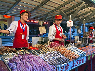 Food stalls at Donganmen night food market near Wangfuging Dajie, Beijing, China, Asia