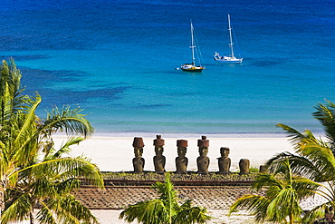 Anakena beach, yachts moored in front of the monolithic giant stone Moai statues of Ahu Nau Nau, four of which have topknots, Rapa Nui (Easter Island), UNESCO World Heritage Site, Chile, South America