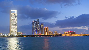 Etihad Towers and Emirates Palace hotel viewed from the Breakwater, Abu Dhabi, United Arab Emirates, Middle East